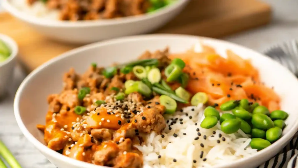 Ground turkey rice bowls topped with fresh veggies and drizzled with a creamy bang bang sauce.
