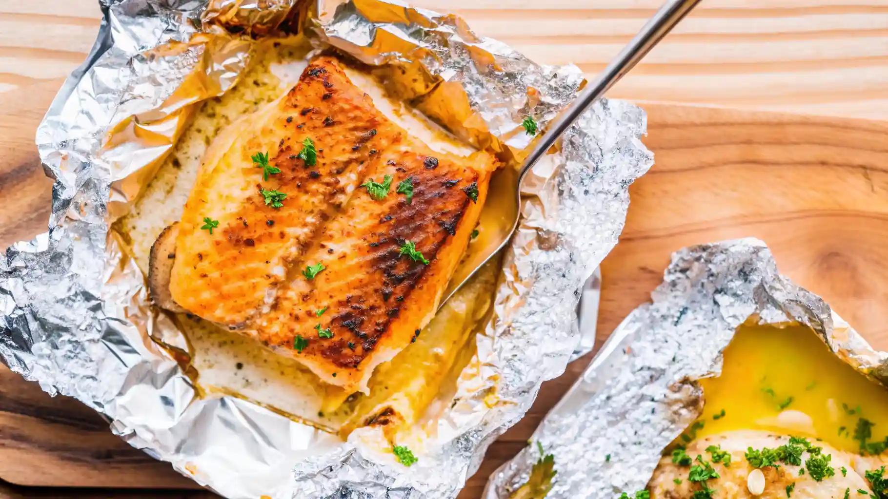 Golden Sheet Pan Lemon Garlic Butter Salmon with flaky fillets nestled among roasted asparagus and cherry tomatoes, glistening with zesty lemon slices and herb-infused garlic butter, ready for an easy healthy dinner on one pan.