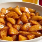 Cinnamon fried apples easy Southern skillet Cracker Barrel copycat 15 minutes with 4 cups Granny Smith apples peeled cored diced bite-size lemon juice tossed prevent browning, large skillet medium heat add 2 tablespoons unsalted butter quarter cup brown sugar quarter cup granulated sugar 1 tablespoon ground cinnamon stirred 3-4 minutes butter melted sugars dissolving glossy bubbling, apples added stirred coated entirely cooked medium heat stirring occasionally 12-14 minutes fork-tender amber caramel syrup coating every piece, served warm vanilla ice cream side dish brunch French toast topping pork chops alongside