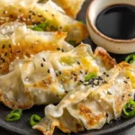 Crispy golden frozen dumplings in air fryer potstickers gyoza cooked at 375F for 8 minutes with oil spray and soy sauce dipping