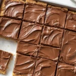 Lunch lady peanut butter bars no-bake retro school cafeteria dessert 15 minutes 9x9 pan — peanut butter base 1 cup salted butter cubed 1 cup creamy peanut butter microwave 50% power 30-second increments stirred smooth, 1 teaspoon vanilla added, 2 cups graham cracker crumbs 1.75 cups powdered sugar folded thick dough pressed parchment-lined 9x9 pan refrigerated, chocolate topping 1.5 cups milk or semisweet chocolate chips 2 teaspoons coconut oil microwaved 30-second intervals stirred smooth poured offset spatula spread even layer refrigerated 2 hours firm set 16 squares sliced served