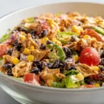 Southwest chicken salad healthy meal prep lunch 15 minutes with 4 cups cooked diced chicken breast 1 cup frozen corn thawed 1 can 15-ounce black beans rinsed drained 1 cup chopped green onions quarter cup fresh cilantro 1 medium red bell pepper diced, creamy lime honey Greek yogurt dressing juice one lime 3 tablespoons juice half lemon 2 tablespoons 2 tablespoons honey 3 tablespoons olive oil quarter cup nonfat Greek yogurt 2 teaspoons cumin half teaspoon oregano 1 teaspoon kosher salt whisked smooth, dressing poured over chicken mixture tossed fully coated, refrigerated served immediately romaine bed or wrap